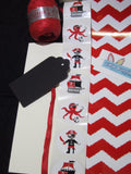 Raffia ribbon, pirate decal, black gift tag and red belly band wrap